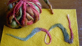 Felted yellow fabric with red and blue swirl